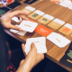 Person at a table handling Emotional Culture Deck